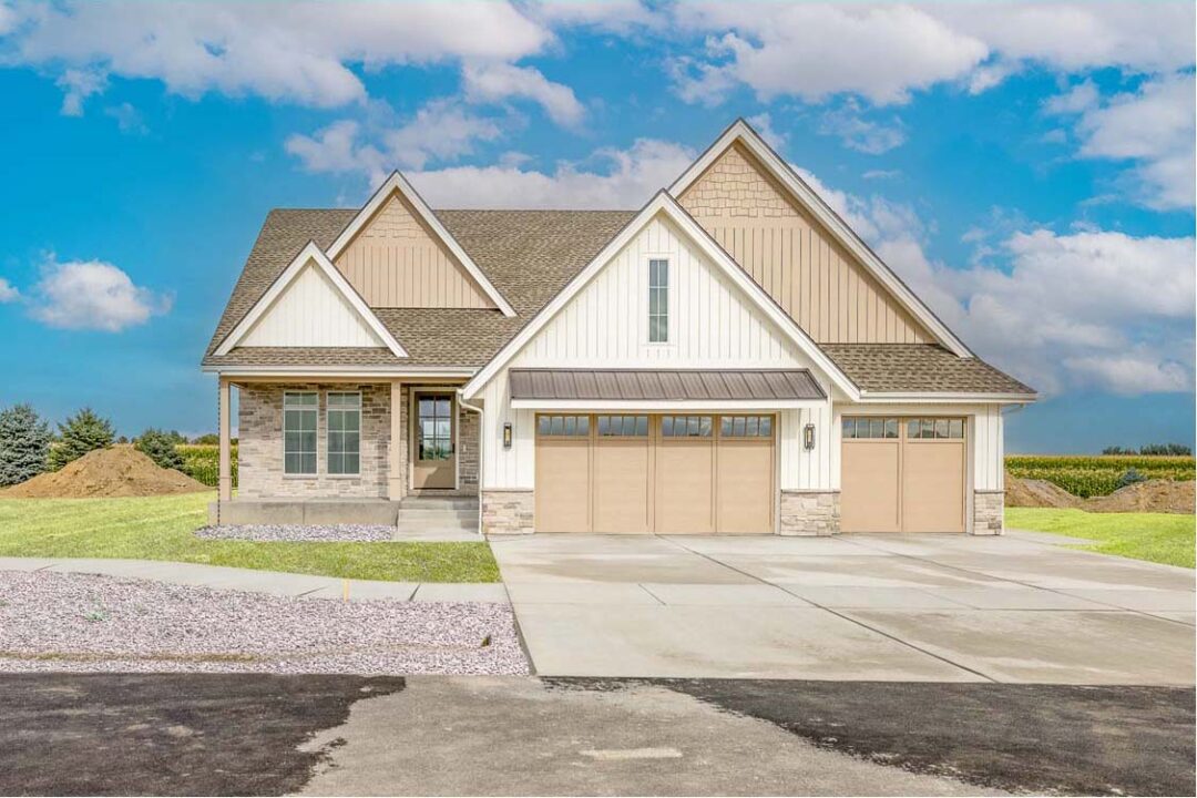 A modern suburban house with a spacious driveway and a well-maintained lawn.